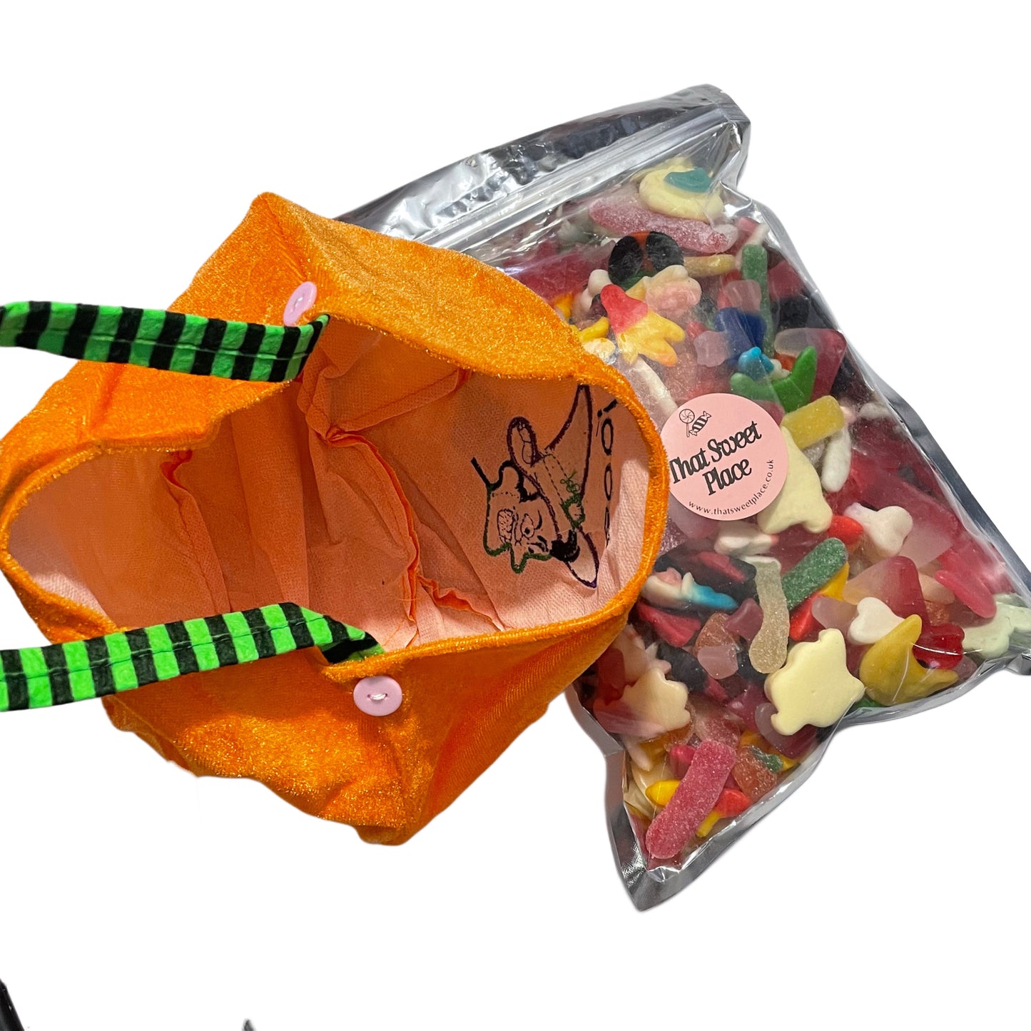 Pumpkin-shaped bag with candy and a pink label reading that sweet place on a white background
