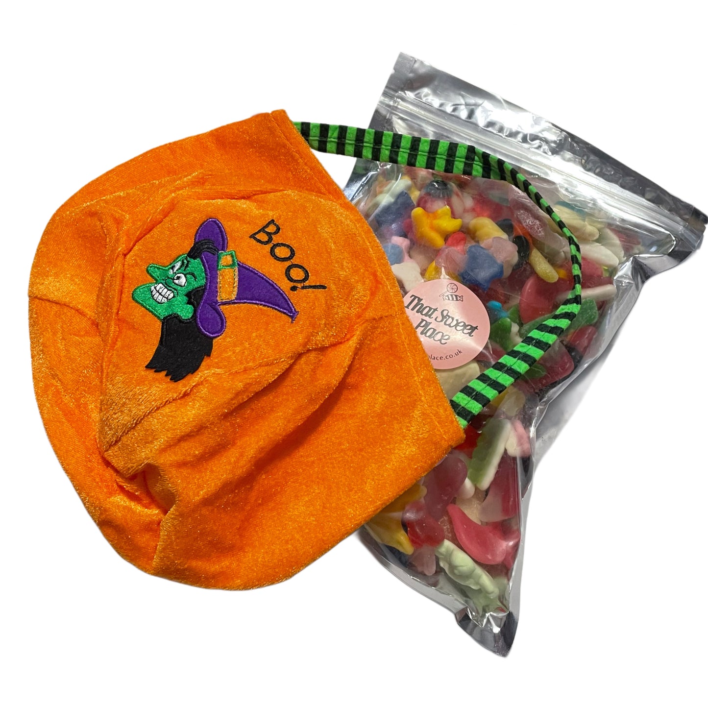 Orange Halloween-themed bag with a witch design and 'Boo!' text, next to a bag of colorful gummy candies.