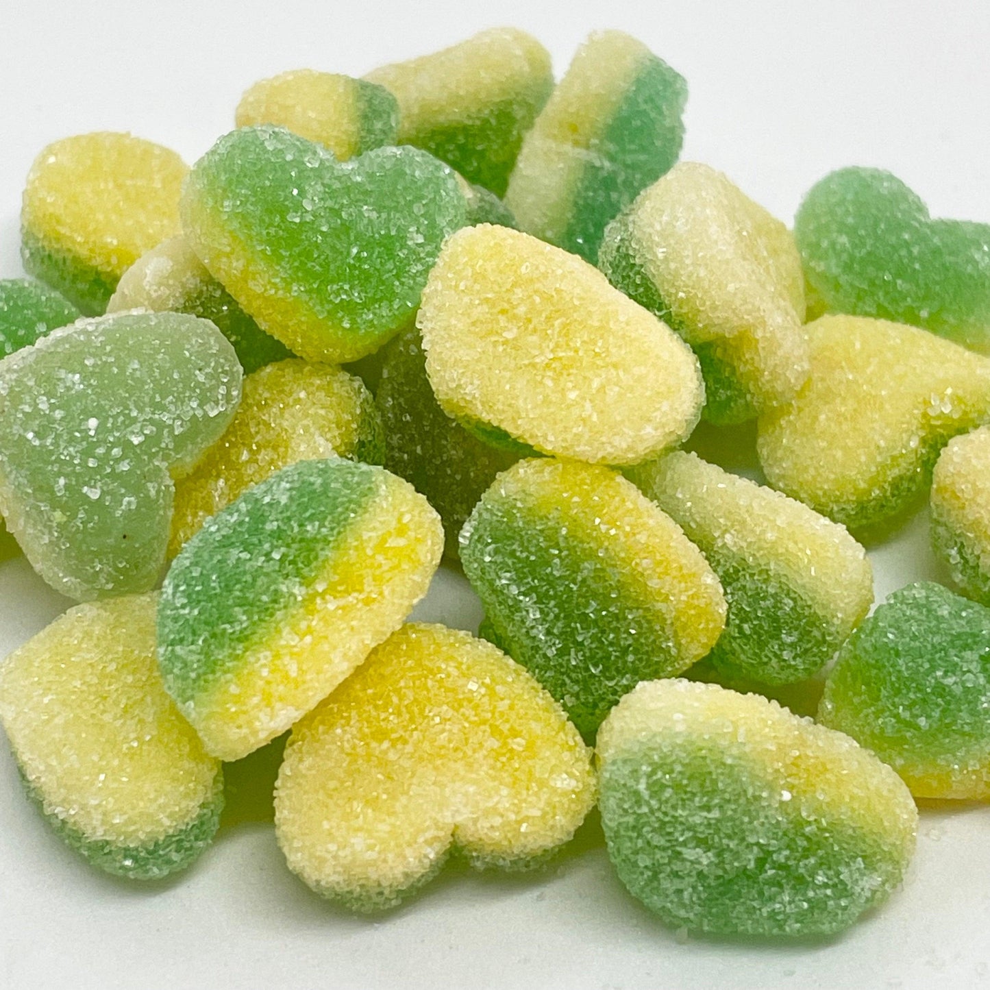Apple and custard hearts are flavourful jelly and foam sweets, featuring a green apple top and a delectable custard foam bottom, all coated with sweet sugar.