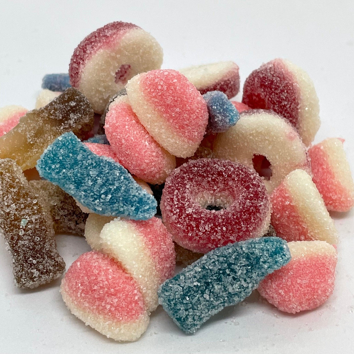Take your taste buds on a wild ride with Fizzy Mix! This mouth watering mix of fizzy and sour gummy sweets includes mini watermelon rings, fizzy cola bottles, blue raspberry bottles, strawberry puffs, and fizzy blue bottles. Experience a burst of flavour and a rush of excitement in every bite Halal Gluten Free Dairy Shop Now