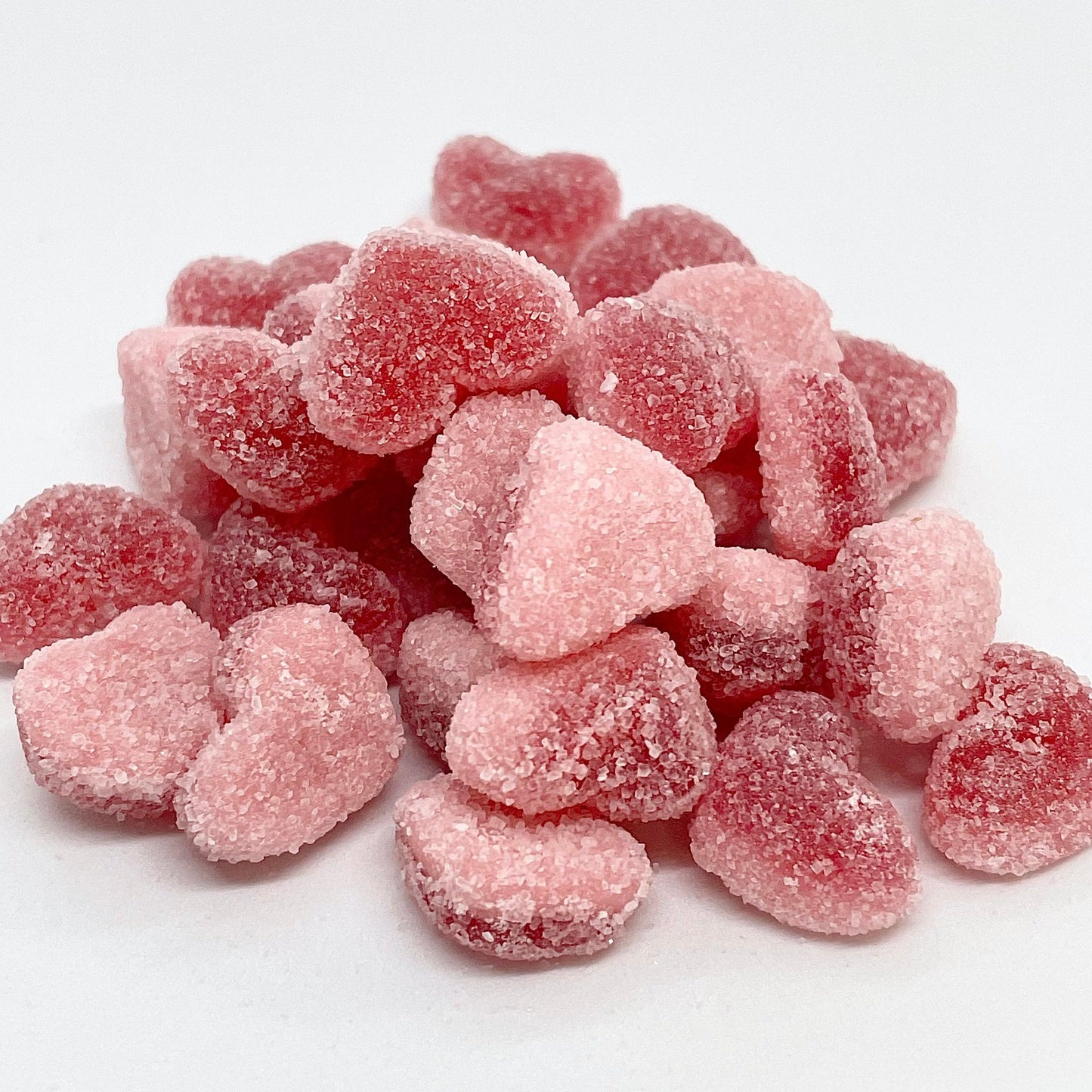 Get your daily dose of sweetness with our Strawberry Hearts! These fizzy gummy sweets feature a delicious jelly strawberry top and a yummy foam bottom, all dusted in a sweet sugar coating. Satisfy your sweet tooth in every bite with these irresistible treats! Available now at That Sweet Place