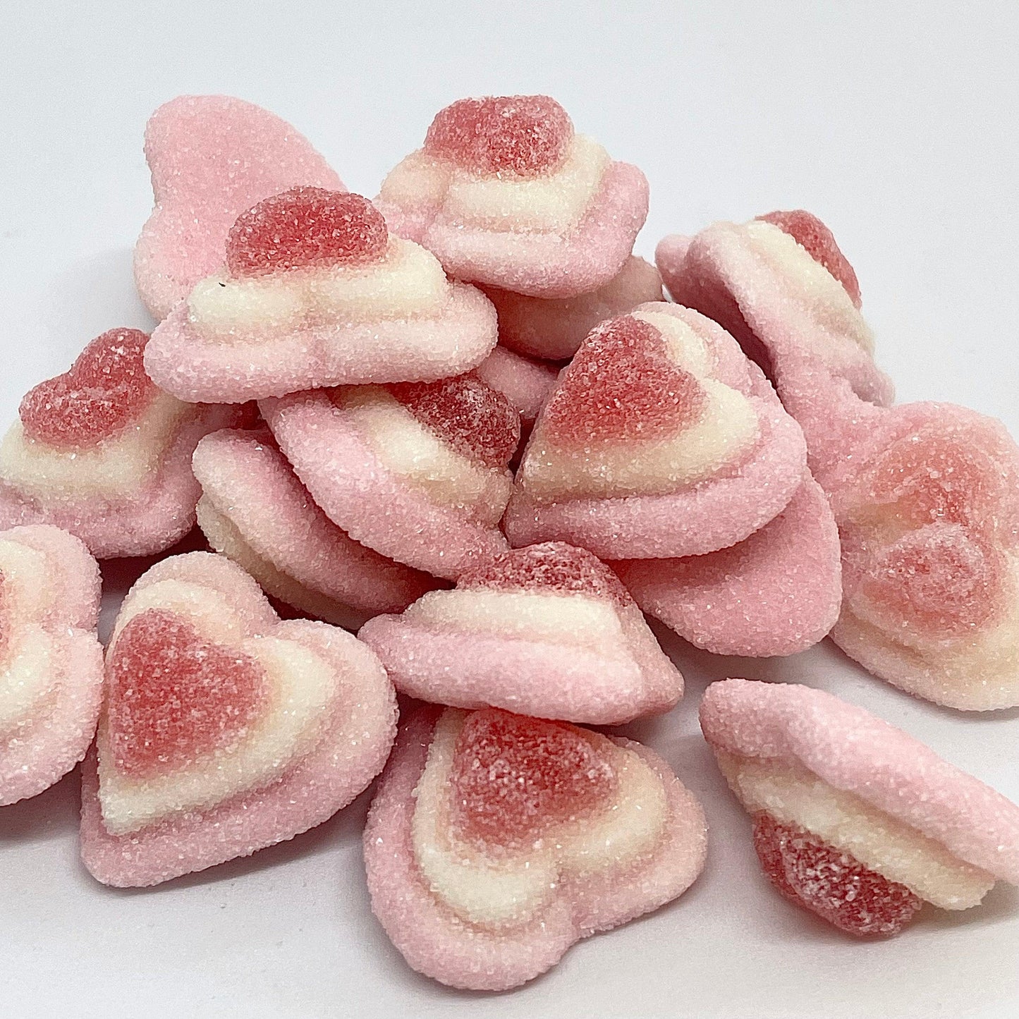 Experience a burst of sweet strawberry flavour with our Triple Hearts! These 3D hearts are coated in delicious sugar, making them a tasty and fun treat. Shop now at That Sweet Place