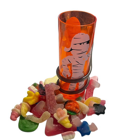 cute mummy tumbler filled with spooky halloween sweet treats